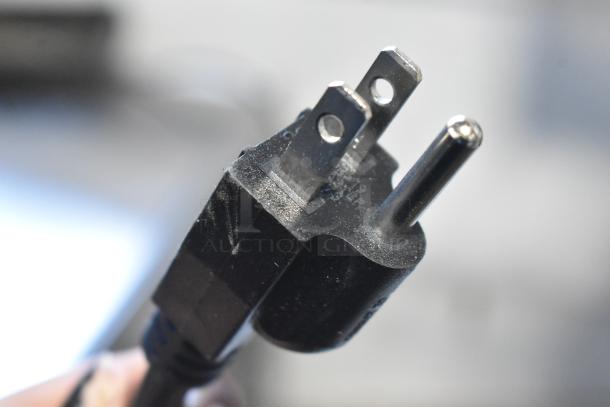 Close-up of a three-prong electrical plug, part of the Fetco TBS-2121 Iced Tea Brewer. Brand new but listed as scratch and dent.