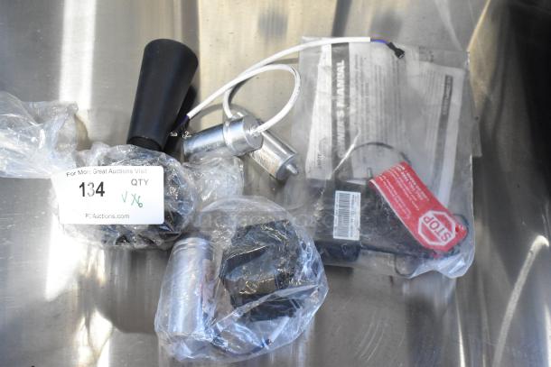 Six brand new scratch and dent items including a 17828004C compressor cover, packed in plastic with visible tags.