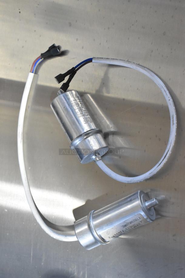 Two metallic cylinder components with attached wires, labeled "17828004C." New condition, part of a scratch and dent auction lot.