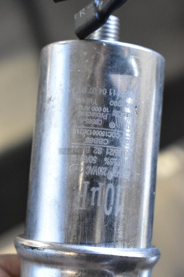 Metallic cylinder showing engraved text including model numbers and technical specifications. Condition appears new.