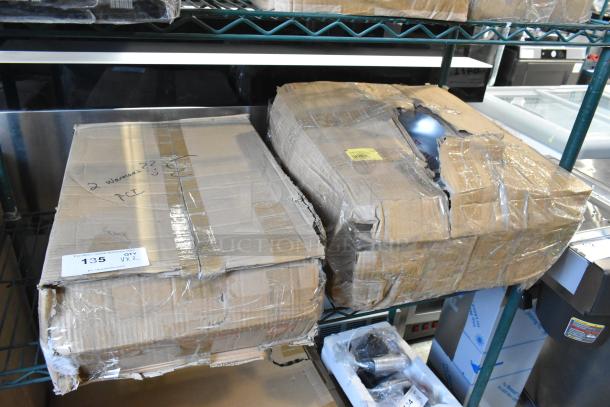 Two brand new scratch and dent items in damaged boxes, including a chafing dish. Labels and markings visible.