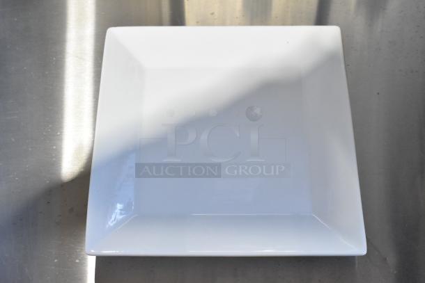 Acopa white ceramic square plate, new with scratch and dent imperfections. Durable, elegant design for versatile use.