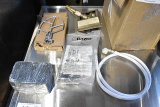 Brand new scratch and dent lot with paddle attachment, hose, Razor packaging; visible wear on cardboard boxes.