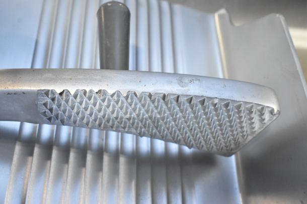 Brand new metal commercial carriage for meat slicer, scratch and dent condition. Textured surface for grip.