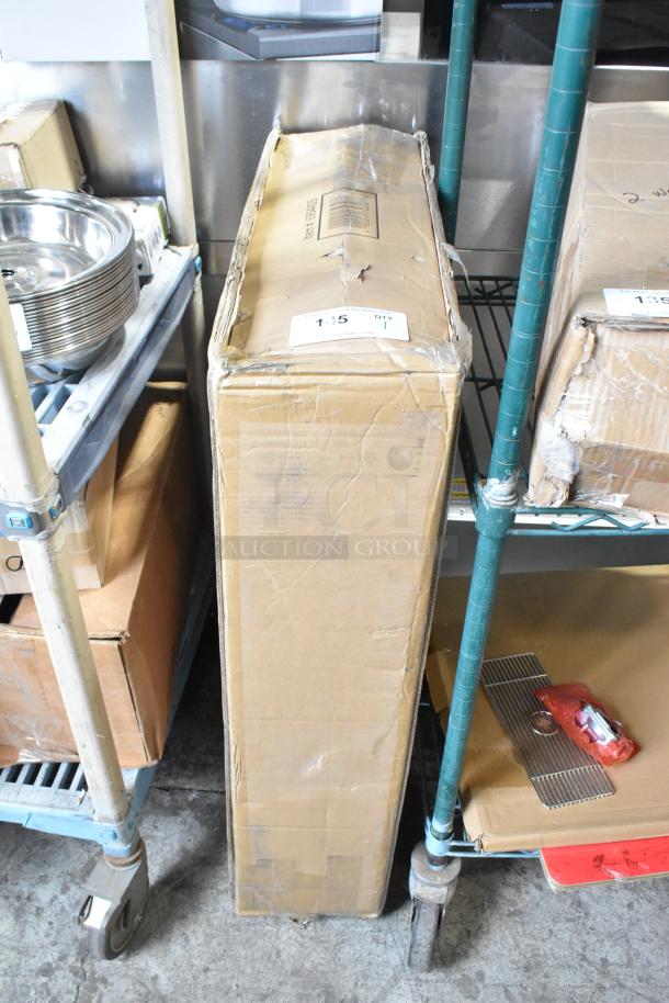 Cardboard box labeled "Lavex" containing a heavy duty platform truck, 36" x 24", 250 lb capacity, ergonomic handle, new with minor box damage.