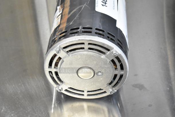 BRAND NEW SCRATCH AND DENT US Motors J63WZB motor, 208-230/460V, slight surface blemishes, detailed shot of end cap and ventilation.