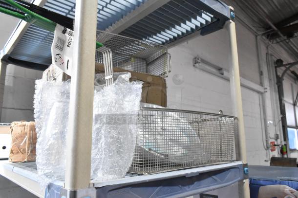 Seven brand new scratch and dent items including Kason door closer and Frymaster fryer basket on a metal shelf, some wrapped in bubble wrap.