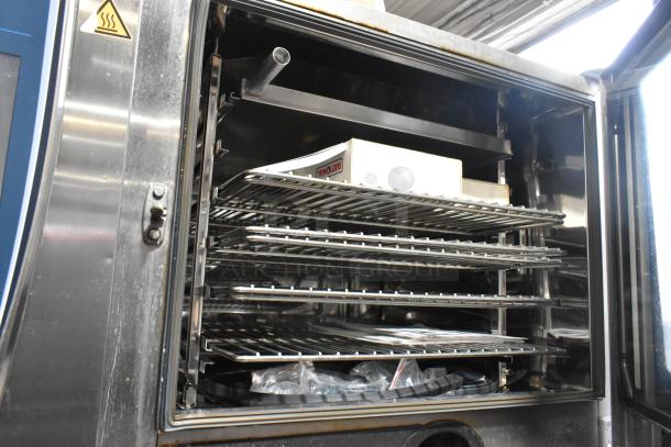 Rational SCCWE62/SCCWE100 iCombiPro ovens, stainless steel, commercial, inside view. Bottom oven has broken glass.