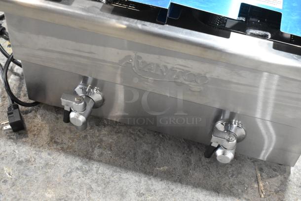 Avantco 177F202 stainless steel dual tank fryer, 30 lb. capacity, new with minor scratches, includes 2 baskets and lids.