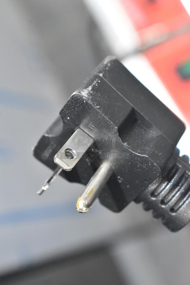 Close-up of a power plug for the Avantco 177F202 dual tank electric fryer, showing a few scratches and minor dents.