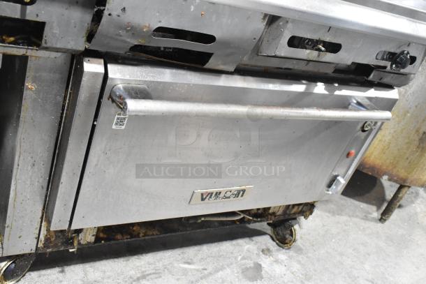 Vulcan V2BG4TS stainless steel griddle with 4 burner range, oven, and back splash on casters. Natural gas, 50,000 BTU.