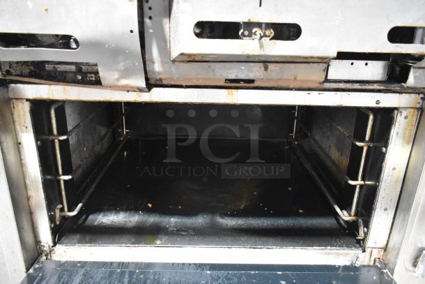 Vulcan V2BG4TS commercial oven interior, showing wear. Stainless steel, spacious for large-scale cooking. 50,000 BTU.
