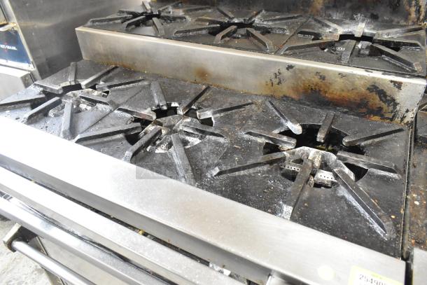 Stainless Steel Commercial Natural Gas Flat Top Griddle with 2 Tier 6 Burner Range, Oven, 50,000 BTU, on casters.