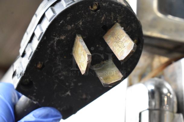 Close-up of a power plug for an Alto Shaam 1000-TH/I oven, showing three prongs with visible wear, 208-240V label.