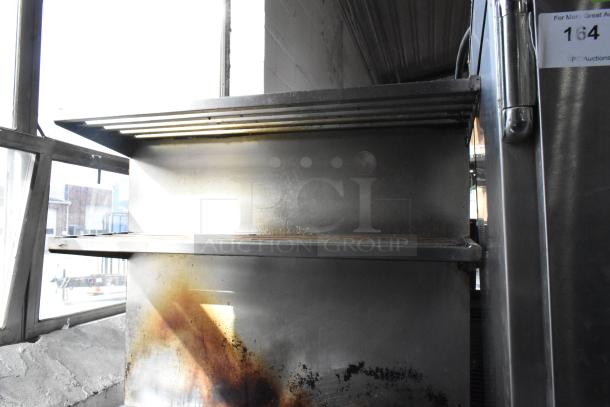 Montague stainless steel commercial flat top griddle with 2-tier 6 burner range, oven, and backsplash. Used condition.