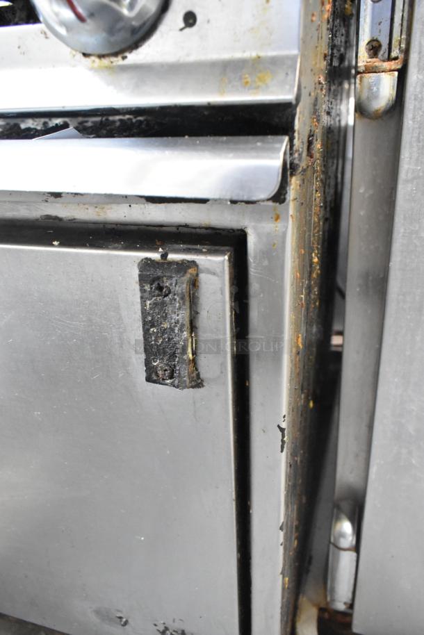 Montague stainless steel commercial natural gas griddle, flat top, 6-burner range, oven, 50,000 BTU, on casters. Slight wear.