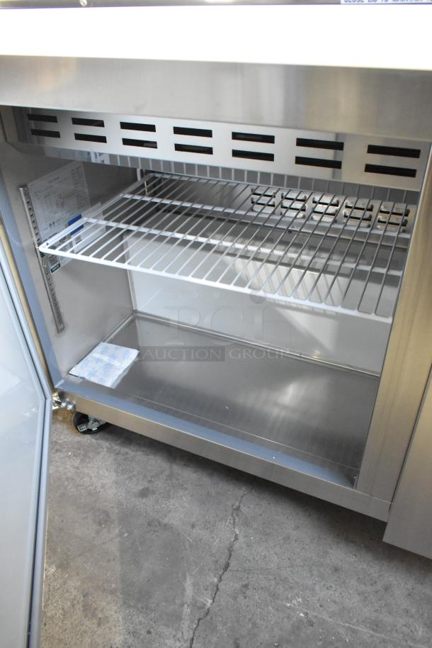 Stainless steel Avantco 178APT60MHC commercial sandwich salad prep table, brand new, scratch and dent, on casters.