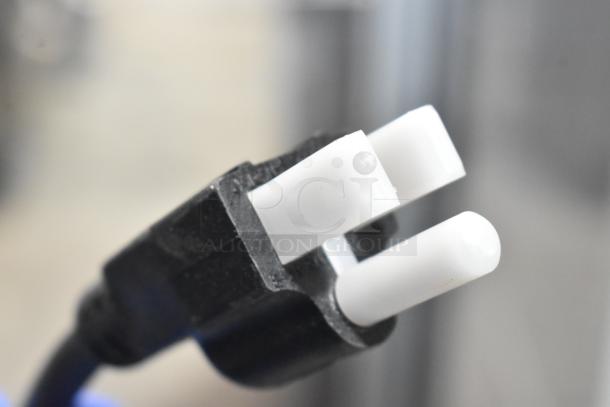 Close-up of Avantco MX10H mixer's power plug, showcasing a sturdy black casing and two white prongs.