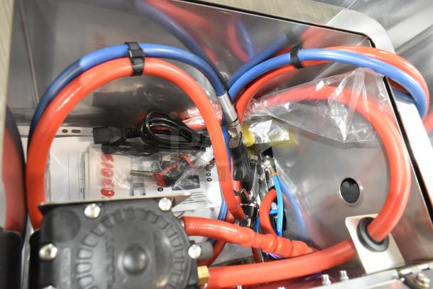 Brand new Pavoni Ciocospritz chocolate sprayer with red and blue hoses. Stainless steel, countertop electric model.