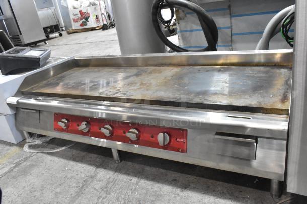 Avantco 177EG60C stainless steel electric griddle. Features countertop design, red control panel, moderate wear. 208V, 3-phase.