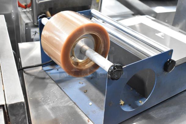 Kopak 4106-1000 metal countertop shrink wrapper, 110 volts, 1 phase. Features film roll and metal frame. Good condition.