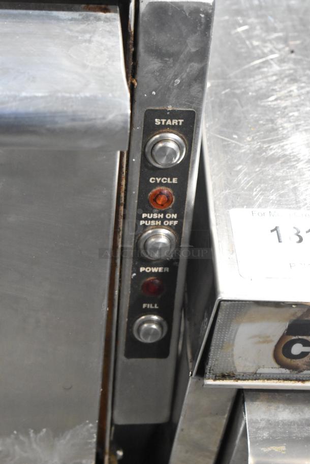 Stainless steel commercial undercounter glass washer, featuring control panel with start, cycle, power, fill buttons; moderate wear.