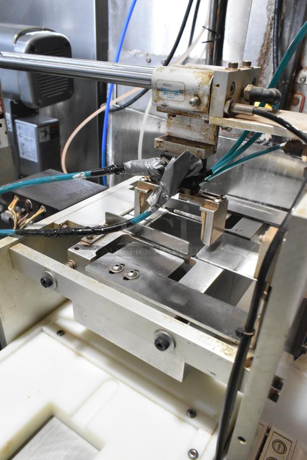 Package Metal Countertop Die Fold Wrapper Machine in used condition, showing metal components, wires, and taped connections.