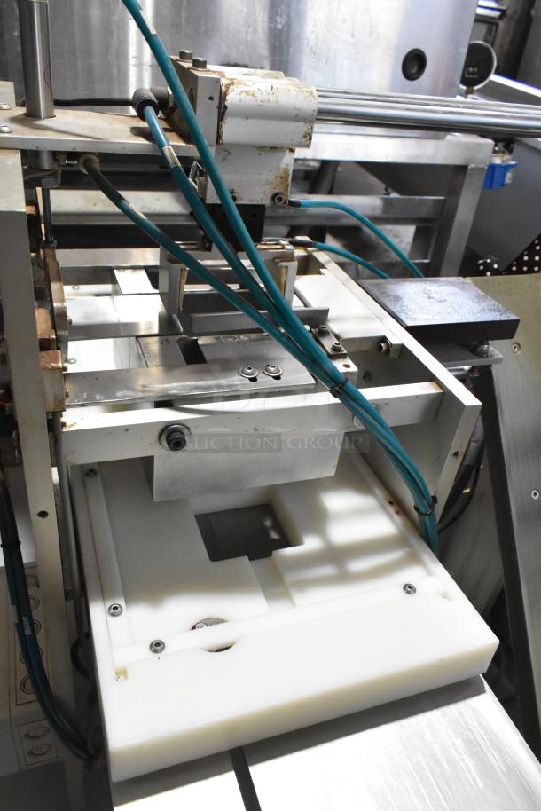 Package Metal Countertop Die Fold Wrapper Machine with blue hoses, metal frame, and white base; used condition.