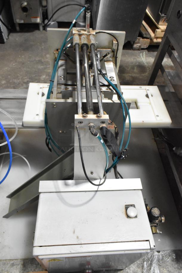 Package metal countertop die fold wrapper machine in full view, showing multiple rods, wires, and a power button. Used condition.