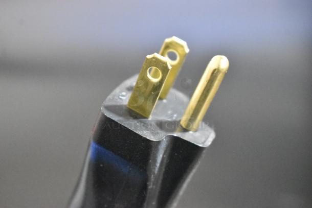 Close-up of a 120-volt plug for the Metro MBQ-120 Stainless Steel Insulated Heated Banquet Cabinet.