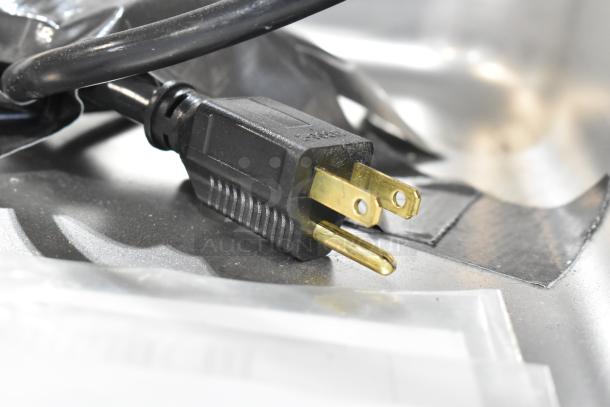 Plug and cord of a Pro-Cut KG-22W stainless steel commercial meat grinder, 115 volts, 1 phase. New with minor scratches.