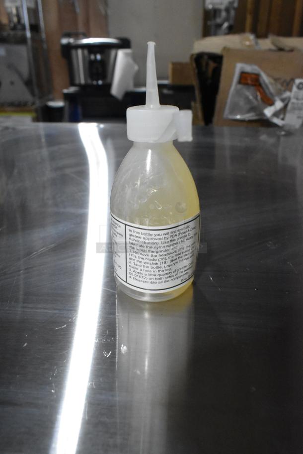 Alt text: Bottle of synthetic grease approved by FDA for lubricating the Pro-Cut KG-22W meat grinder, label with instructions.
