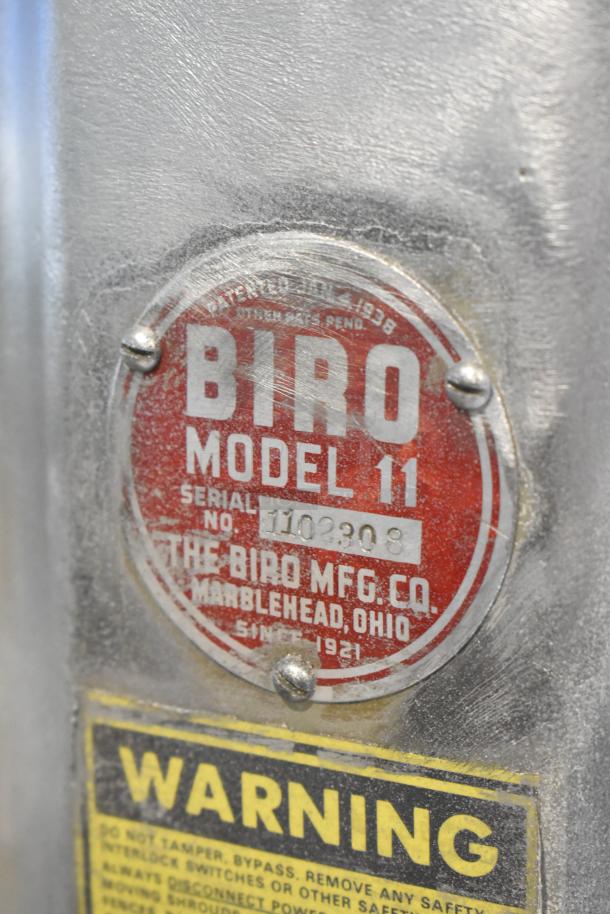 Biro Model 11 commercial meat saw label, showing serial number 1102308. Features metal construction with visible warning label.