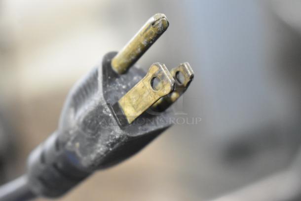 Close-up of a three-pronged power plug from an Automatic MJ Metal Commercial Countertop Food Processor.