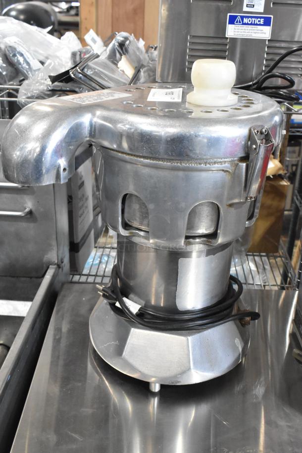 Stainless steel commercial countertop juicer, 115 volts, 1 phase, includes power cord. Used condition with wear marks.