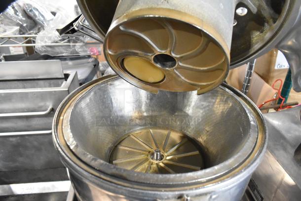 Stainless steel commercial countertop juicer, 115 volts, 1 phase. Features durable metal components and mesh filter. Good condition.