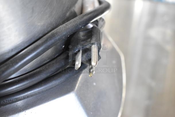 Stainless steel commercial countertop juicer plug, 115 volts, 1 phase, showing black power cord and pronged plug.