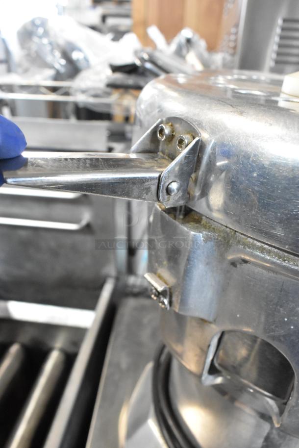 Stainless steel commercial countertop juicer, 115 volts, 1 phase, used condition, with lever handle detail.