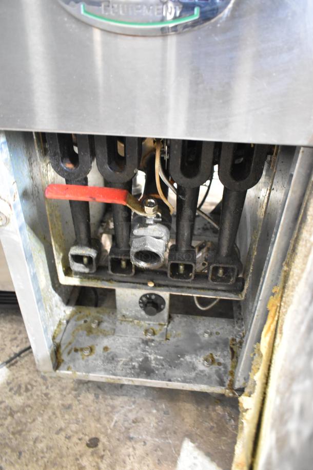 Mainstreet 541FF50N stainless steel gas fryer, 120,000 BTU. Door issue, visible wear. Model number visible on the unit.