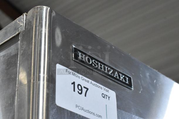 Hoshizaki KM-501MWH stainless steel commercial ice head on bin, shows brand logo and auction label, some wear visible.
