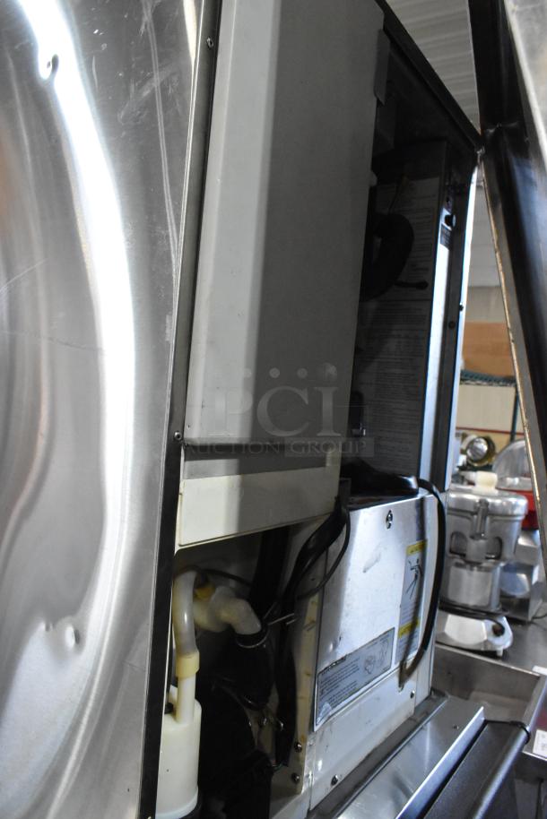 Hoshizaki KM-501MWH stainless steel commercial ice head on bin; 115-120V, 1 phase; partially open; internal components visible.