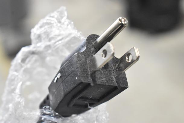 Power plug of a 2025 Avantco 177BW32 stainless steel commercial warming drawer wrapped in bubble wrap.