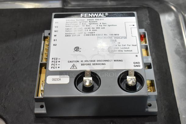 Fenwal automatic ignition system, model 2462D-506-011, new condition with minor dents. High voltage warning label visible.