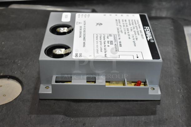 Fenwal control unit, brand new condition, minor scratch and dent. Diagnostic labels and wiring terminals visible.