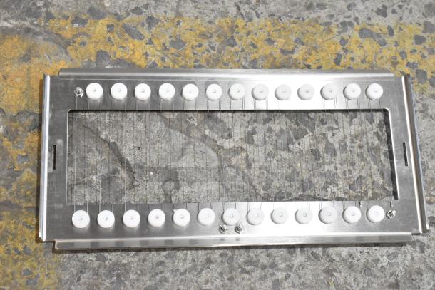 Stainless steel cutter frame with wire strings, featuring white rollers. New condition despite scratches. Ideal for industrial use.