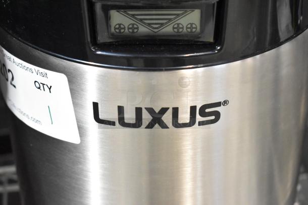 BRAND NEW Fetco Luxus L4S-15 1.5 Gallon Coffee Server, stainless steel, minor scratches and dents, model label visible.