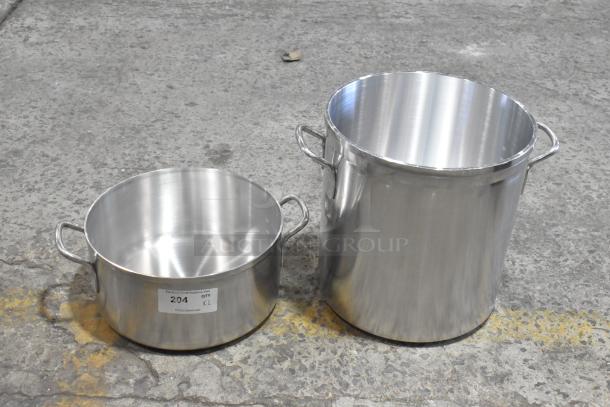 Brand new stainless steel stock pots with minor scratches and dents. Two sizes shown; one labeled "204 QTY x2".