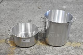 Brand new stainless steel stock pots with minor scratches and dents. Two sizes shown; one labeled "204 QTY x2".