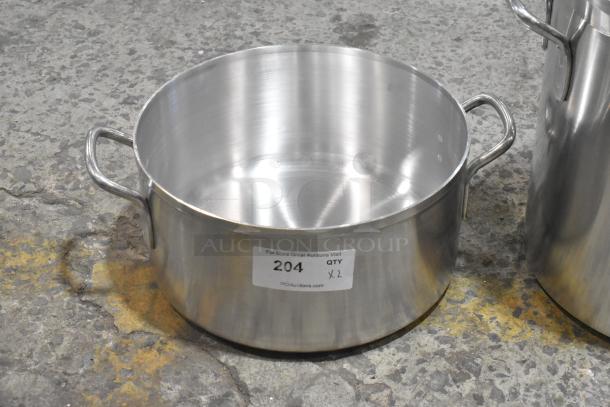 Brand new stainless steel stock pot, minor scratches, dented. Dual handles, smooth interior. Auction label: "204 QTY x2".