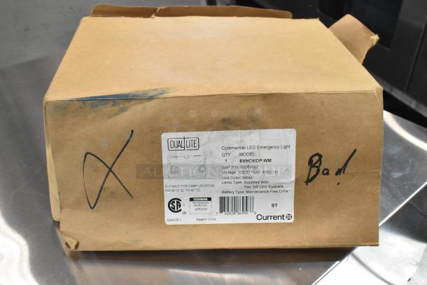 Cardboard box with label for Dual-lite EVHC6IDP-WM LED Emergency Light. Box marked "Bad" and shows signs of wear.